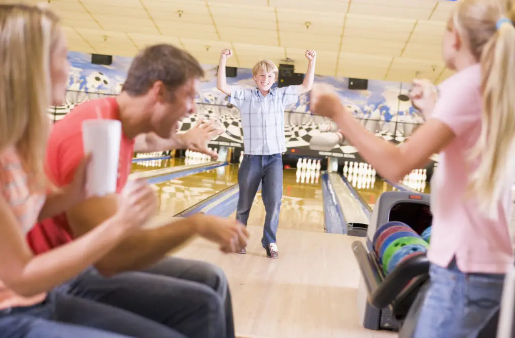 A family bowling together. 