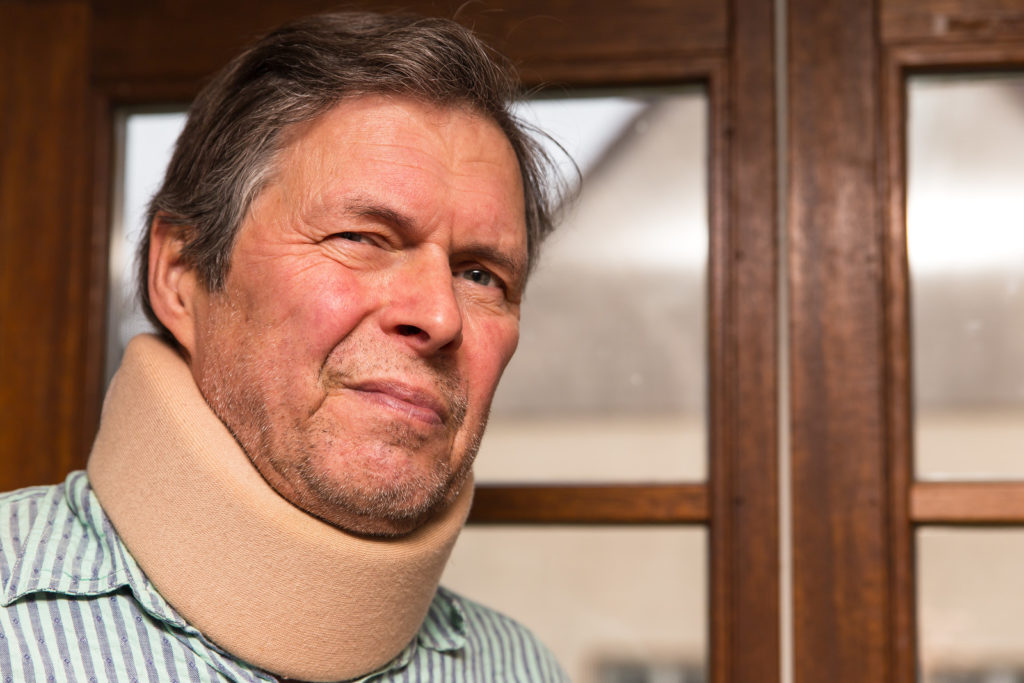 A man wears a brace around his neck.