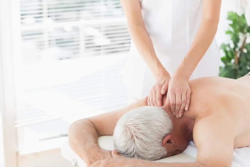A senior man gets a massage. 