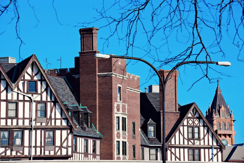 German style buildings in Champaign Illinois with a bright blue sky and old trees