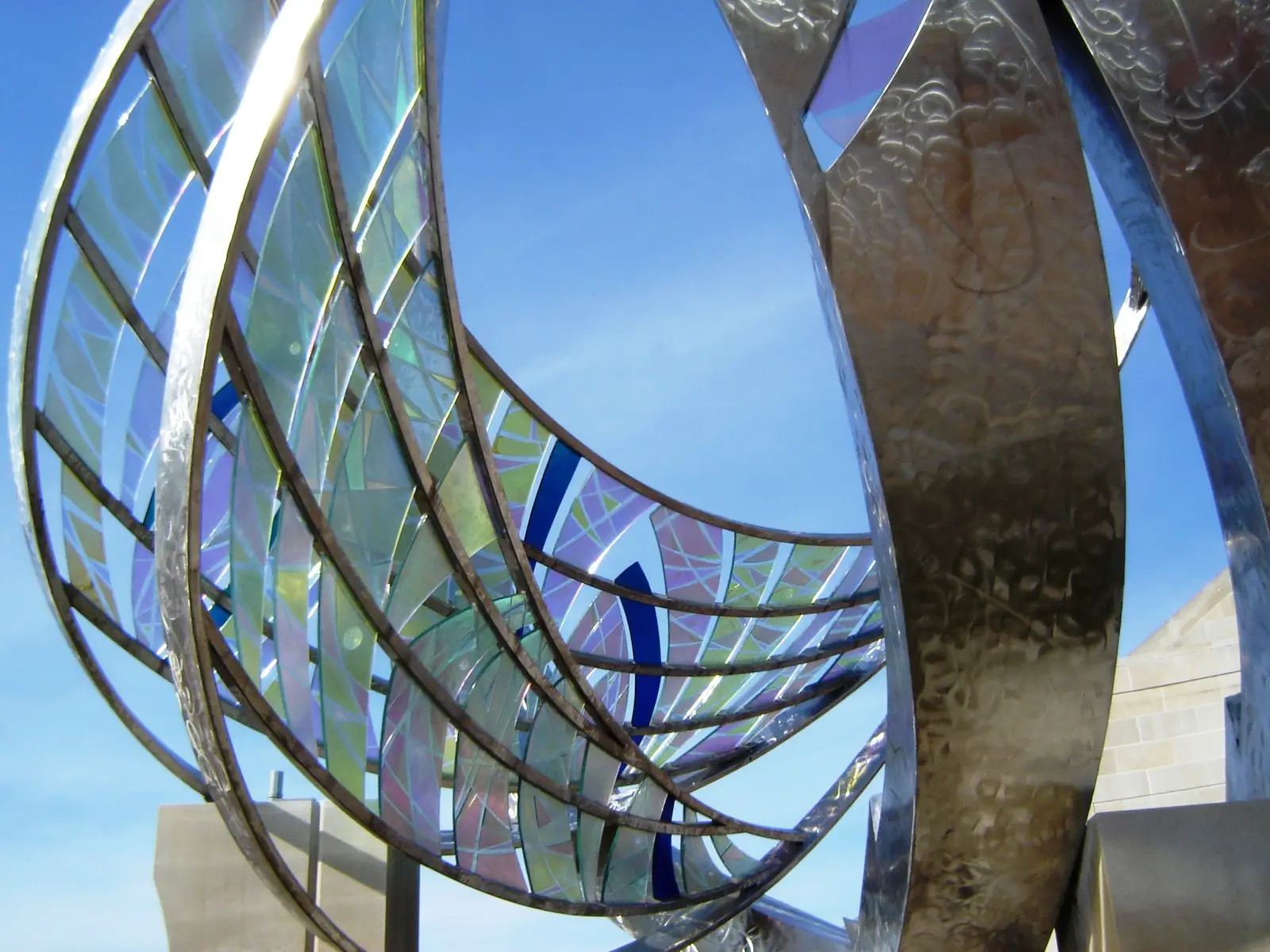 Glass and metal sculpture outside of Minnetrista with a blue sky background, the Ball Jar Company, in Muncie Indiana