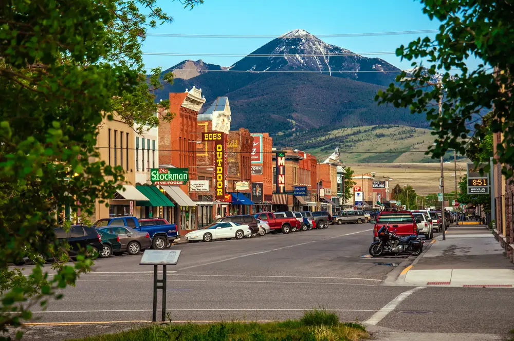 The main street and city center in Livingston Montana where the sky is blue overhead and the buildings are colorful